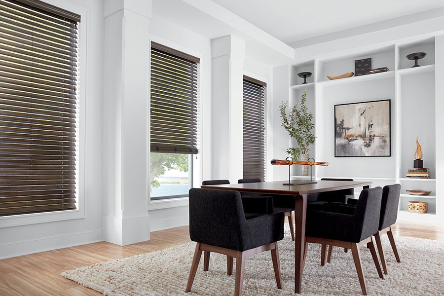 Dark brown window blinds on three dining room windows